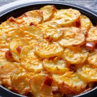 Cheesy Potatoes & Ham · Potatoes and ham baked in a creamy cheese sauce.