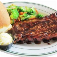 Hickory Smoked Baby Back Ribs · Tender slow roasted baby back ribs covered in our smoky bbq sauce, half rack.