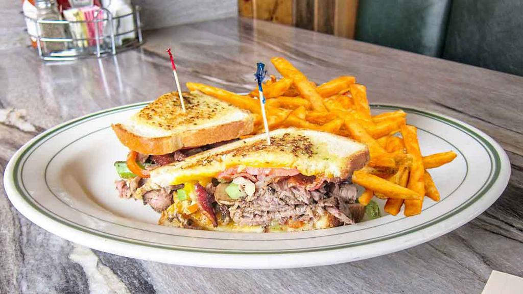 The Chain Saw · Roast beef, bacon, tomatoes, sautéed onions and mushrooms, bell pepper and cheddar cheese with special dressing and served on grilled sourdough.