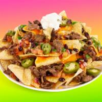 Carne Asada Nachos · Melty nachos loaded with carne asada, melted cheese, pico de gallo, pinto beans, and your ch...