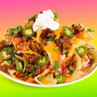Al Pastor Nachos · Melty nachos loaded with al pastor, melted cheese, pico de gallo, black beans, and your choi...