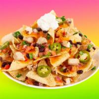 Chicken Mole Nachos · Melty nachos loaded with chicken mole, melted cheese, pico de gallo, black beans, and your c...