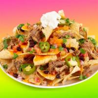 Carnitas Nachos · Melty nachos loaded with carnitas, nacho cheese, pico de gallo, pinto beans, and your choice...
