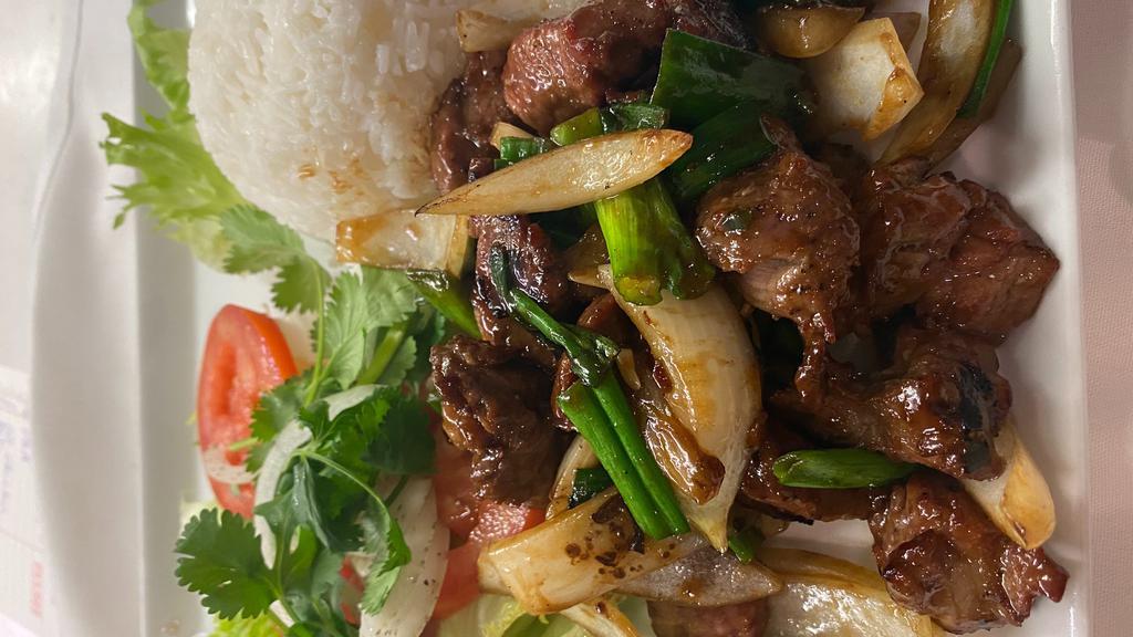 Shaking Beef · Marinated garlic and onion beef cubes sautéed to perfection on a bed of fresh greens. Served with steamed rice.