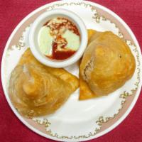 Vegetable Samosa · Two pieces. Crispy turnover, filled with mild spice, potatoes and, green peas.