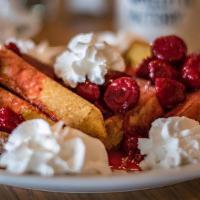 Strawberry French Toast · Our old fashioned French toast topped with strawberries and whipped cream.