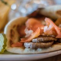 Gyros Sandwich · Savory gyros meat stuffed into pita bread with tomatoes and onions. Served with your choice ...