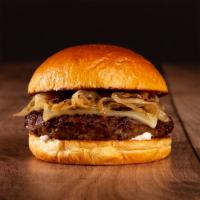 The Truffle Burger · Beef patty, caramelized onions, truffle mayo, and melted swiss cheese on a brioche bun.