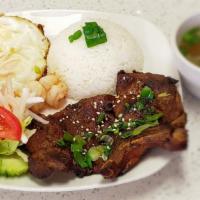 Grilled Pork Chop With Eggs & Shrimps · It comes with a side of steamed rice.