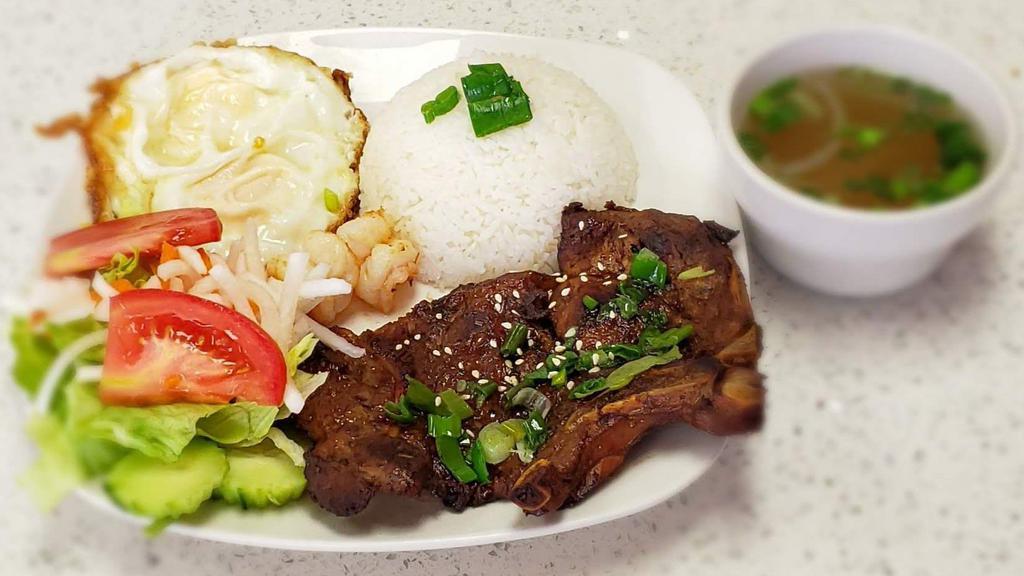 Grilled Pork Chop With Eggs & Shrimps · It comes with a side of steamed rice.