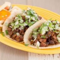 Asador Burrito · Carne asada or chicken tinga, abuela's rice, black beans, cabbage, pico de gallo, chipotle a...