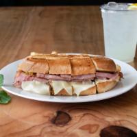 Cuban Mixto · Grilled pulled pork, ham, American-Swiss cheese, pickle, and mustard pressed on a buttered h...