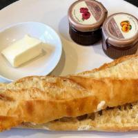 Les Tartines · Half fresh baked baguette (toasted or plain) with butter and jam.