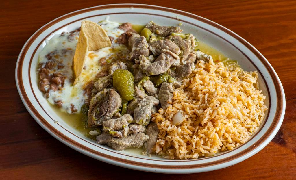Chile Verde · Sliced pork simmered in a blend of spices, and mild green chili peppers. Served with rice, and beans.