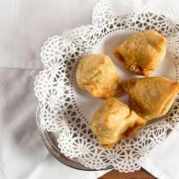 Vegetable Samosa · A pastry with spiced potatoes and onions.