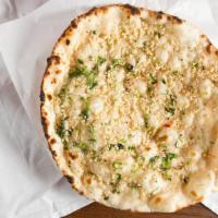 Garlic Naan · India oven specialty. Indian style garlic bread baked on the sides of our tandoori oven.