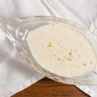 Kheer · Rice pudding served with almonds, raisins, and pistachios.