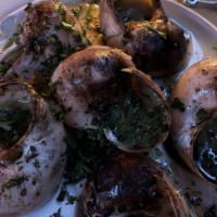Escargots Persillade · half a dozen burgundy snails, garlic butter, parsley.