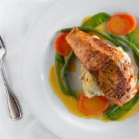 Blackened Salmon  · in a citrus sauce with mashed potatoes and vegetables.