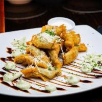Artichoke Hearts · Tender artichoke hearts fried in a house-made beer batter, served with pesto aioli and mild ...