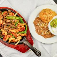 Mixed Fajitas · Steak, chicken, and shrimp, with an exquisite preparation of onion, bell peppers mushrooms, ...