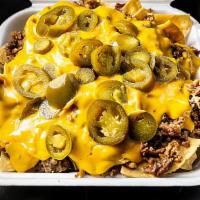 Asada Nachos · Freshly made tortilla chips with nacho cheese sauce, jalapenos, onions and our delicious hom...