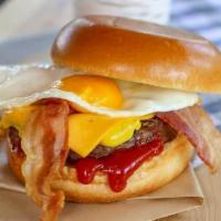 Egg Run Burger · Fried egg, bacon, cheddar cheese, ketchup and 5oz beef patty on a brioche bun.