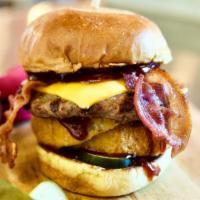 Texas Burger · 5oz patty, American cheese, bbq sauce, onion rings, pickles and bacon