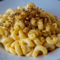 Mac N Cheese · Vegetarian. House made cheese sauce with elbow pasta, topped with panko breadcrumbs.