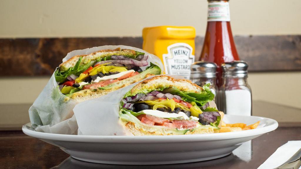 Green Machine Panini · Vegetarian. Cream cheese, avocado, roasted red bell peppers, cucumbers, sprouts, tomato, red onion, black olives, pepperoncini, lettuce, pepper plant sauce, garlic spread, brown mustard, focaccia.