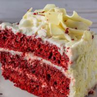 Sliced Red Velvet Cake · A red-hued chocolate layer cake, filled and iced with a smooth cream cheese frosting.
