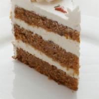 Sliced Carrot Cake · Alternating layers of carrot cake spiced with cinnamon, chopped walnuts, and pineapple, cove...