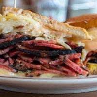 Pastrami Reuben Sandwich · Grilled pastrami, Swiss cheese, sauerkraut and russian dressing on grilled rye. Served with ...