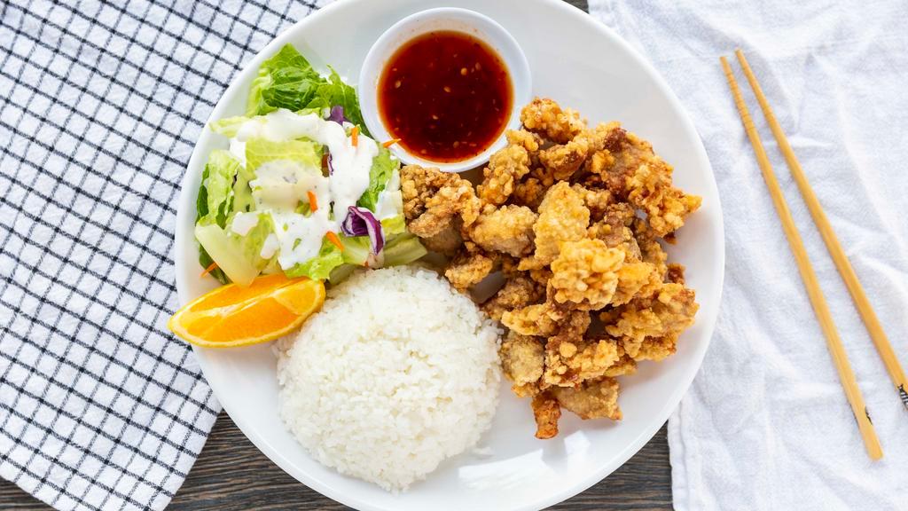 Spicy Pork · Served with steamed rice, green salad, and an orange slice. Spicy