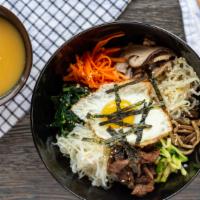 Bi Bim Bap · Rice with beef, assorted vegetables, sunny-side-up egg on top and spicy sauce.