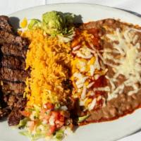 Carne Asada · Marinated sirloin steak served with a delicious cheese enchilada, rice, beans, and garnished...