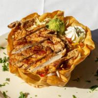 Fajita Tostada · A fried flour tortilla shell with grilled vegetables, beans, shredded lettuce, jack and ched...