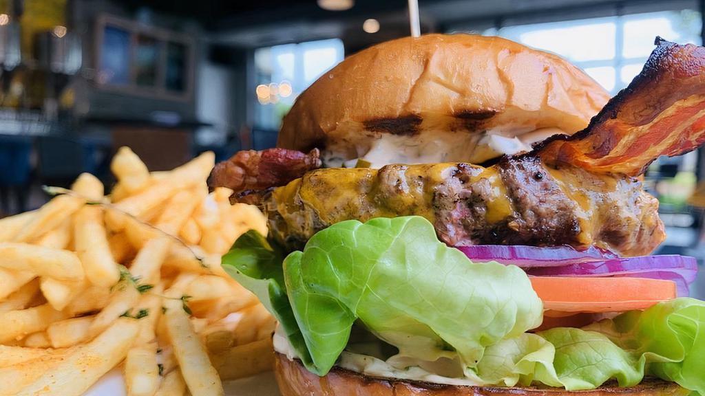 Ebullition Burger · A 1/2 lb patty, lettuce, red onion, tomato, house made spread, hand slice bacon on potato brioche.  Comes with fries.