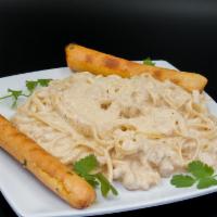 Pasta Alfredo · Fettuccine tossed with chicken breast on alfredo sauce. served with 2 breadsticks and parmes...