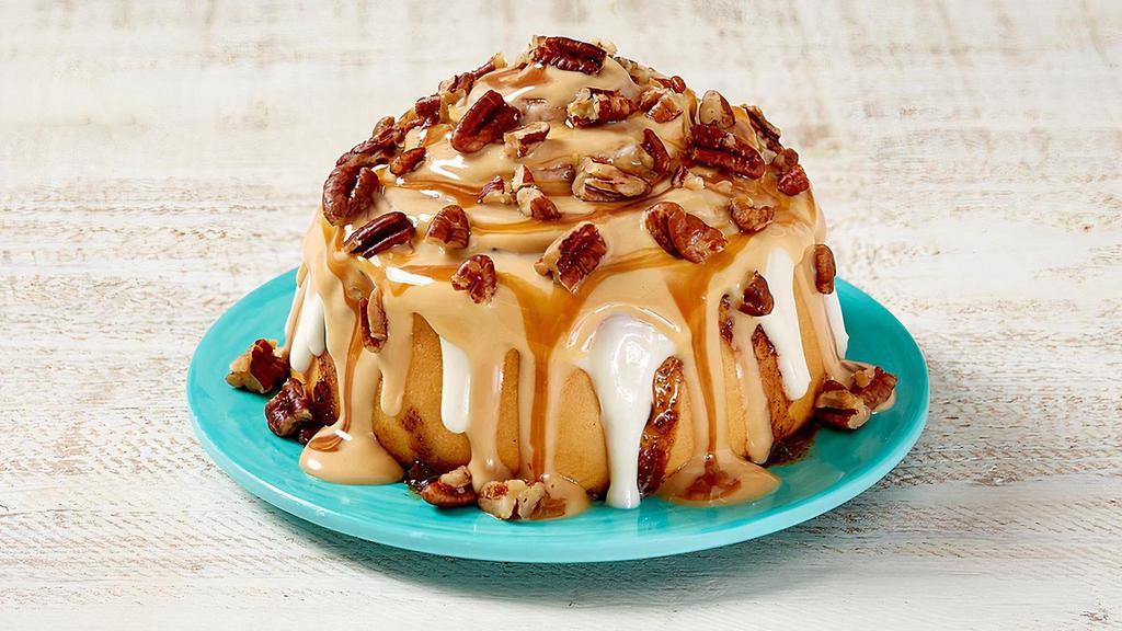 Caramel Pecanbon® · Warm dough, legendary Makara® Cinnamon, topped with caramel frosting, and pecans. Classic with a caramel twist.