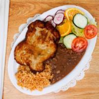 Milanesa De Pollo · Breaded chicken breast served with rice, beans, salad and 4 hand made tortillas.