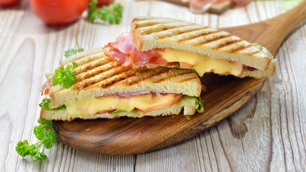 Ham & Cheese Panini · Fresh sliced ham, locally grown avocado, and a hone mustard spread grilled to perfection along with choice of side.