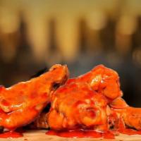 Bone-In Buffalo Wings · Wings tossed with buffalo wings sauce served with your choice of blue cheese or ranch.