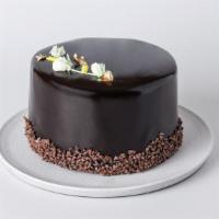 Beverly Cake · Yellow cake layered with Cordillera chocolate mousse, vanilla cream and rich ganache wrapped...