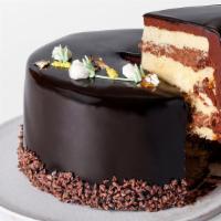 Slice Beverly Cake · Yellow cake layered with Cordillera chocolate mousse, vanilla cream and rich ganache wrapped...