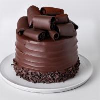 Dark Chocolate Cake · Divine fair-trade chocolate cake with chocolate buttercream and frosted with dark Cordillera...