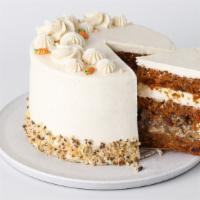 Slice Carrot Cake · Rich carrot cake full of spices, walnuts and raisins, layered with walnut-caramel filling an...