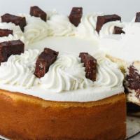 Slice Brownie Cheesecake · Vanilla cheesecake filled with Cordillera dark chocolate brownies in a graham cracker crust,...