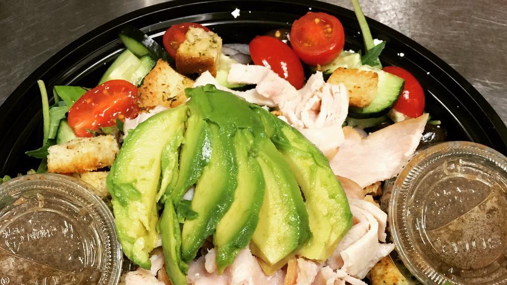 Turkey Greek Salad · Spring mix, Diestel Farms turkey, feta cheese, avocado, cucumbers, tomatoes, Kalamata olives, red onions & house made croutons with house made Greek dressing