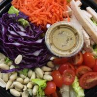 Thai Chicken Salad · Romaine lettuce, cubed chicken breast, red cabbage, carrots, tomatoes & peanuts with house m...